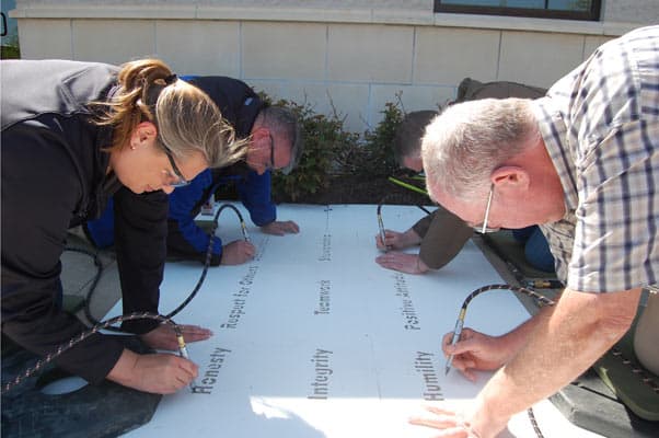 MidwayUSA Employees Engrave 9 Company Values in Campus Sidewalks